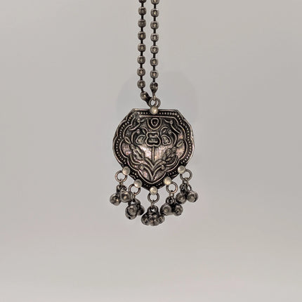 Silver necklace with pendant on a gray background